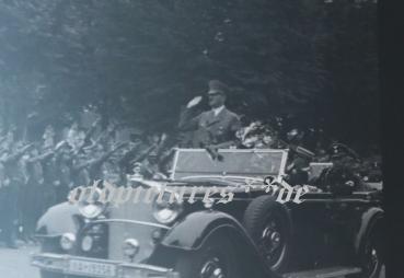 two snapshots including negatives - Adolf Hitler drives through town - 1936 - Olympic flag