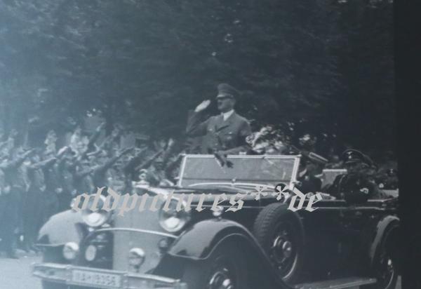 two snapshots including negatives - Adolf Hitler drives through town - 1936 - Olympic flag